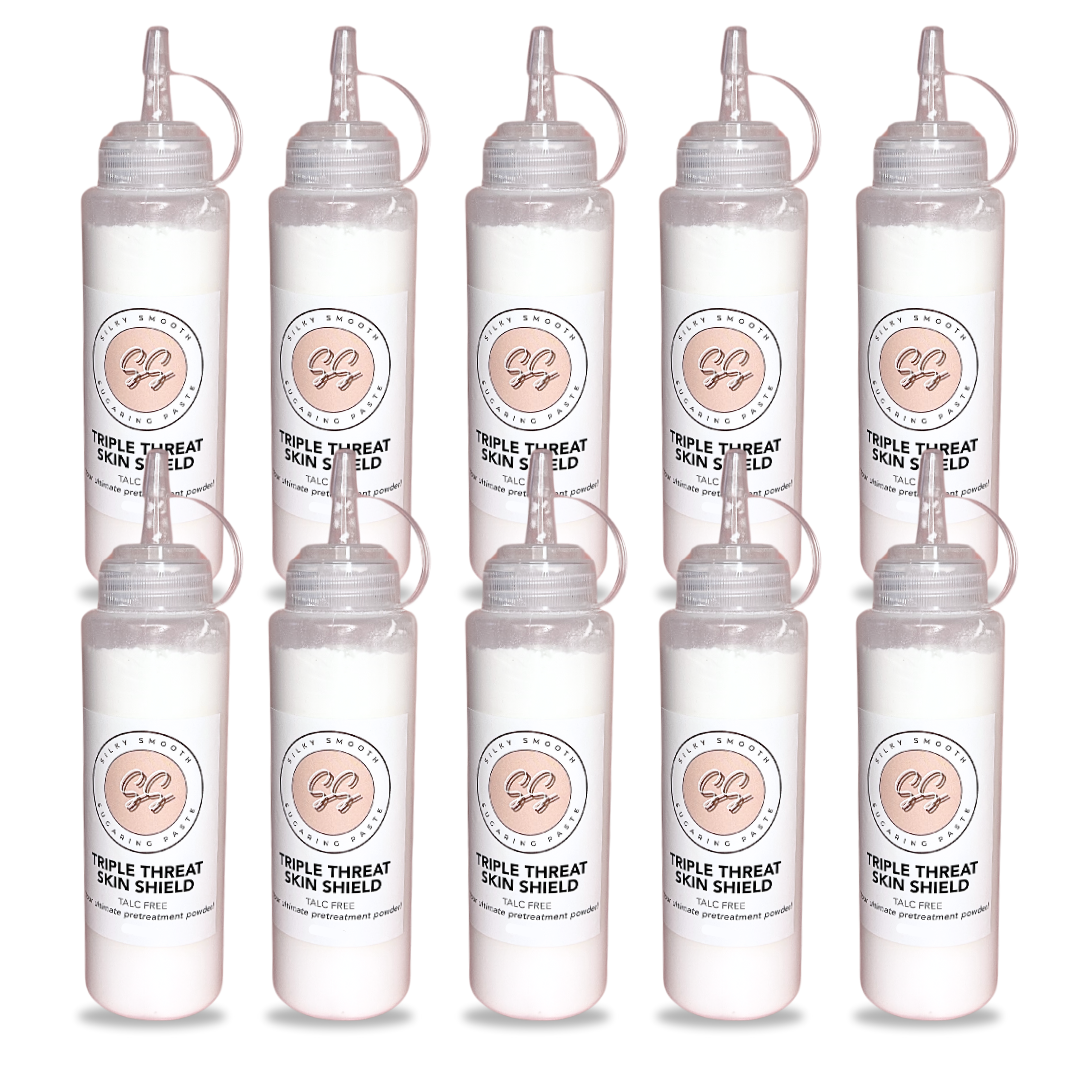 Set of eight clear bottles with labels on a white background